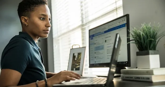 digital worker in front of laptop