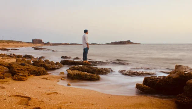 man standing on a beach